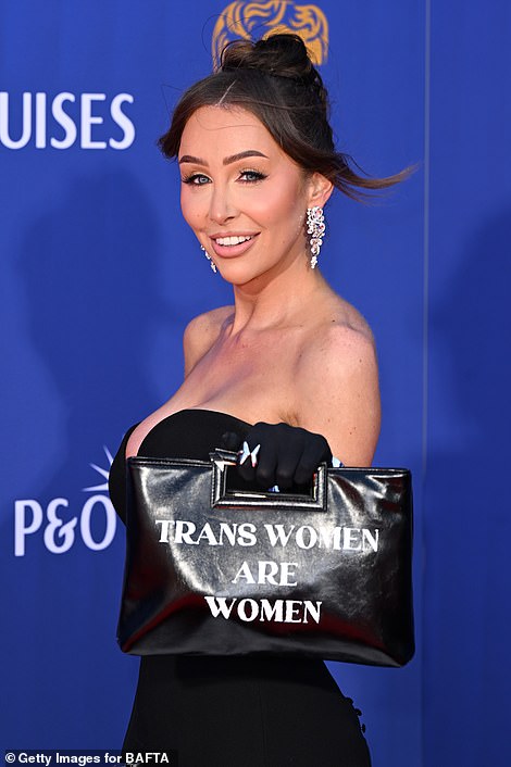 She held up her clutch bag which had a trans rights message on each side in a bold statement
