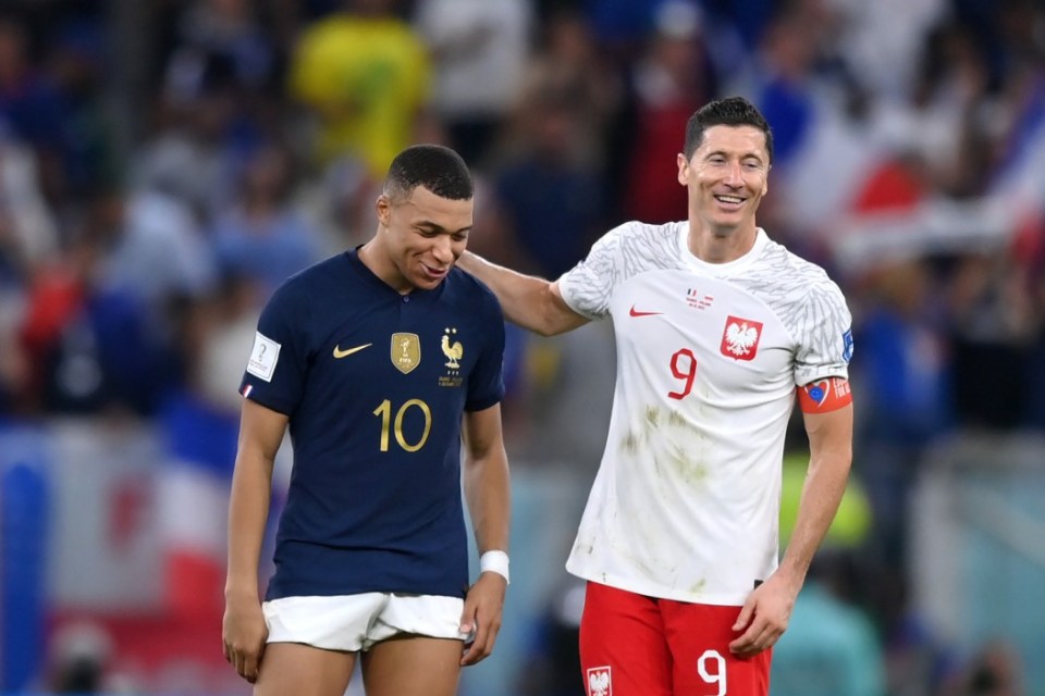 DOHA, QATAR - DECEMBER 04: Robert Lewandowski of Poland embraces Kylian Mbappe of France after the FIFA World Cup Qatar 2022 Round of 16 match between France and Poland at Al Thumama Stadium on December 04, 2022 in Doha, Qatar. (Photo by Justin Setterfield/Getty Images)
