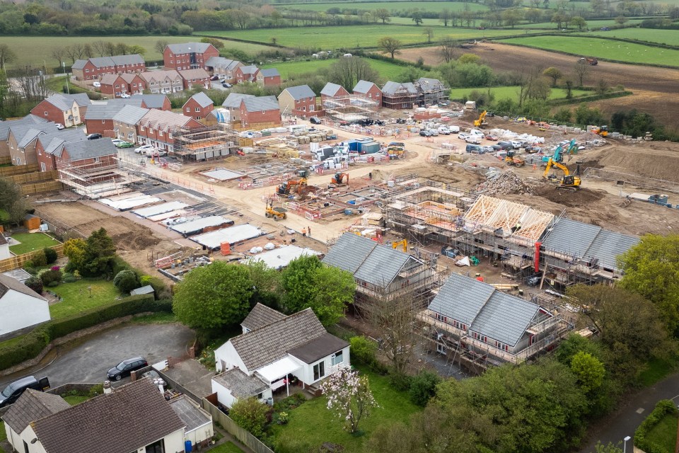 Aerial view of a housing estate under construction next to existing homes.