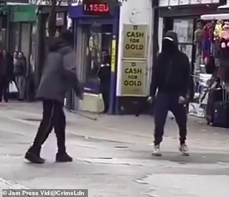 In this chilling footage, two men who appear to be armed with machetes, were seen confronting each other at a packed market in East Ham, east London in October