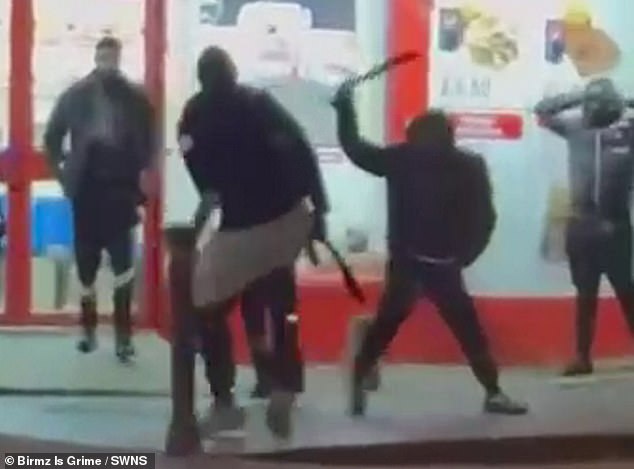 Pictured is the moment two men, armed with machetes, attacked one another outside a fried chicken shop in Birmingham - just 250 yards from Aston Villa's grounds in the city - in March