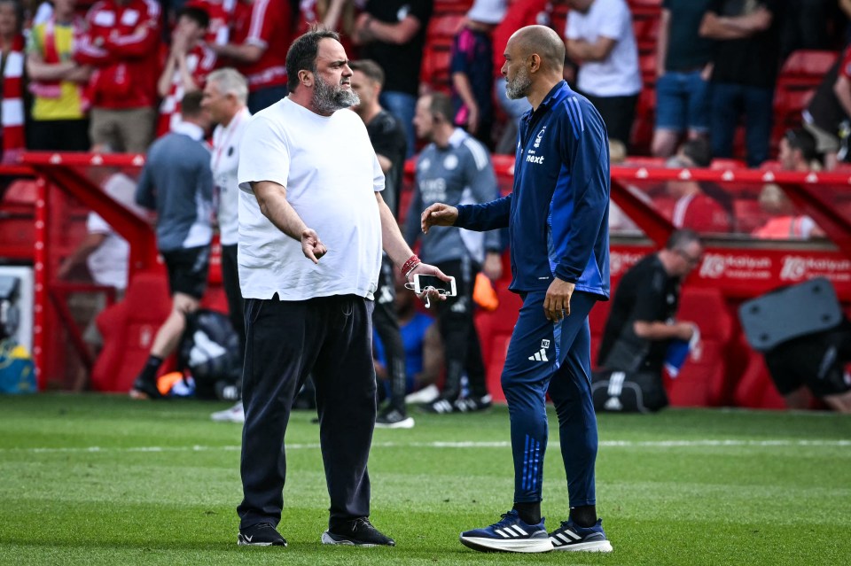 Two men interacting on a soccer field.