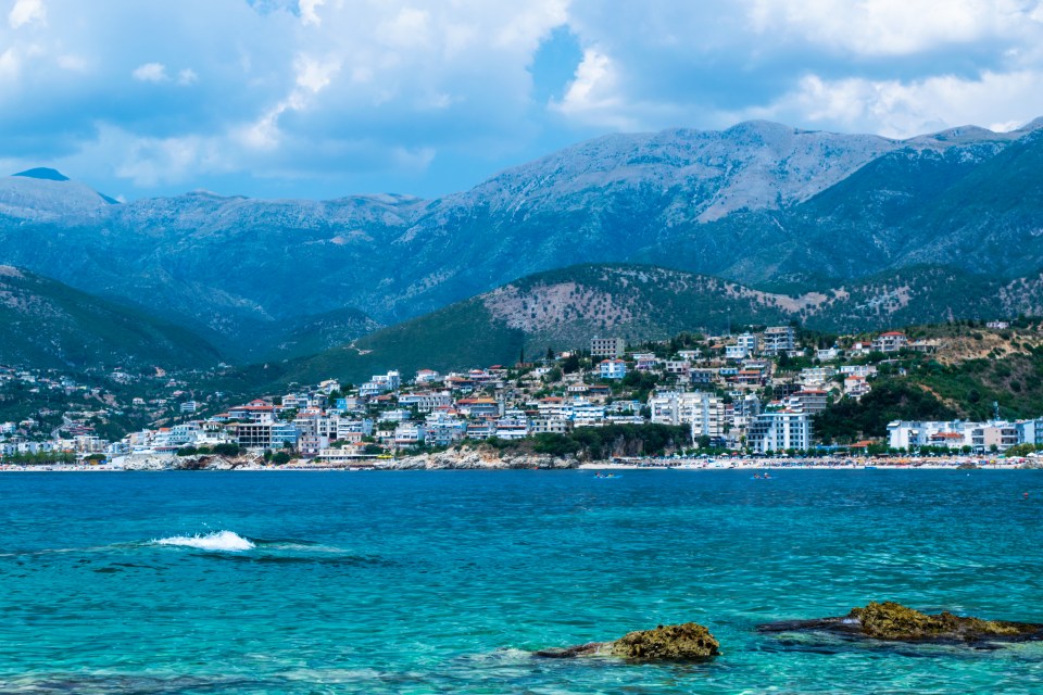 a large body of water with mountains in the background