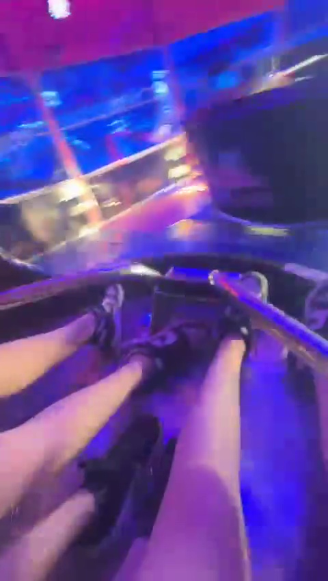 Person's legs on a carnival ride.