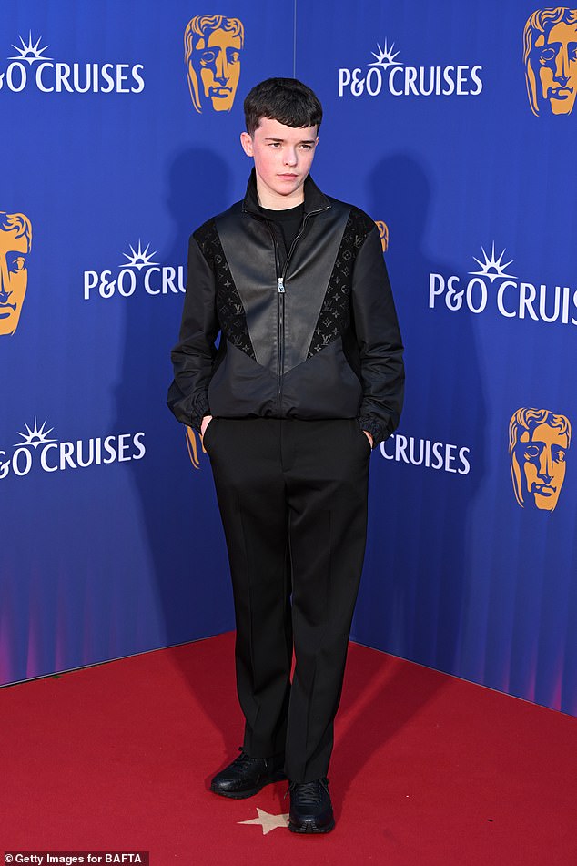 Owen paired his designer piece with tailored black trousers, a casual black T-shirt and chunky black leather shoes