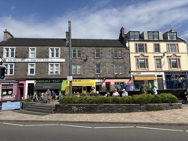 Colourful shopfronts line the streets by the pier selling ice creams and hearty meals