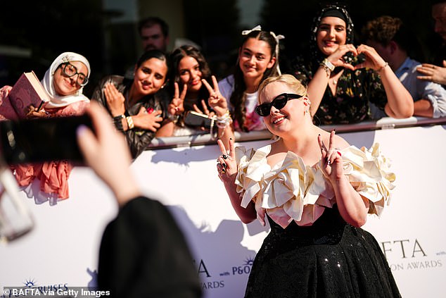Nicola looked on cloud nine while stopping to snap some fun shots with fans