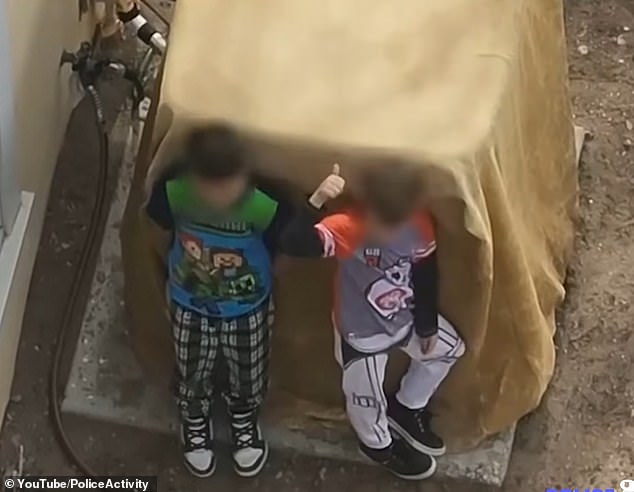 One of the children can be seen giving a thumbs-up to officers, despite ignoring their pleas