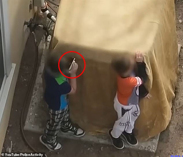 Drone footage sees the duo, wearing Minecraft and Star Wars pajamas, pass a fully loaded gun back and forth between them