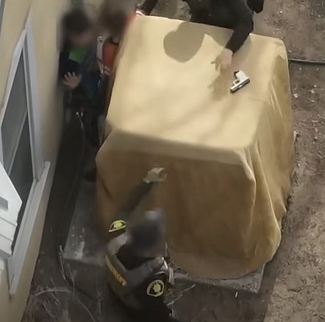A drone captured the moment police managed to finally snatch the gun and keep it well away from the children