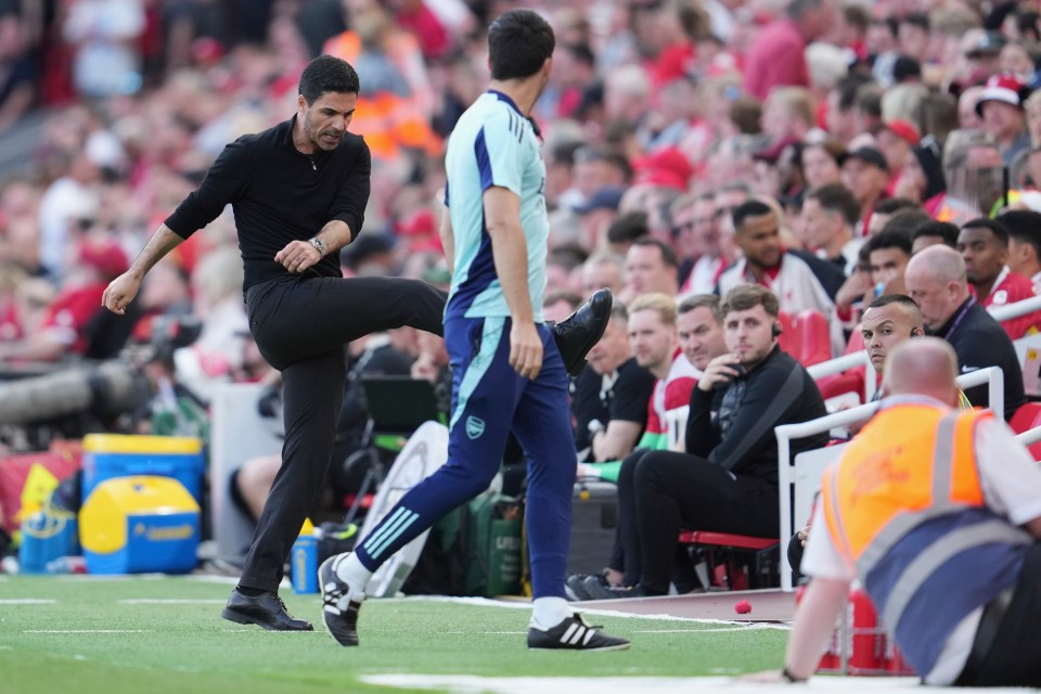 Mikel Arteta, Arsenal's manager, playfully kicks a ball.