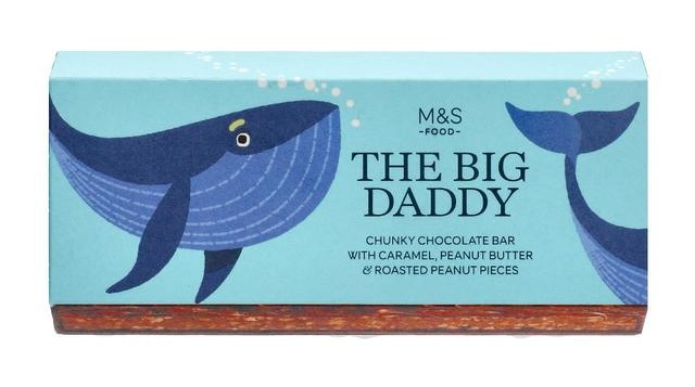 Illustration of a whale on a chocolate bar wrapper; "The Big Daddy" chunky chocolate bar with caramel, peanut butter & roasted peanut pieces.