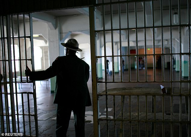 The prison is now a museum and tourist attraction for visitors. Pictured: A National Park Service ranger walking through the old dining hall