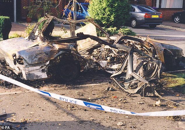 One car was blown up while parked near a police station. Pictured is the wreckage