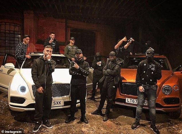 The east London-based Hellbanianz gang have been boasting about their lawless lifestyle on Instagram. Pictured: Members of the gang drape themselves on luxury cars