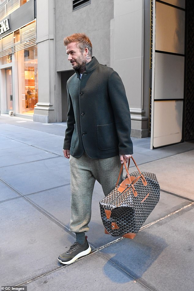 David also opted for a low-key look in a pair of slouchy trousers tucked into a pair of green trainers, while also adding a button up coat to the ensemble