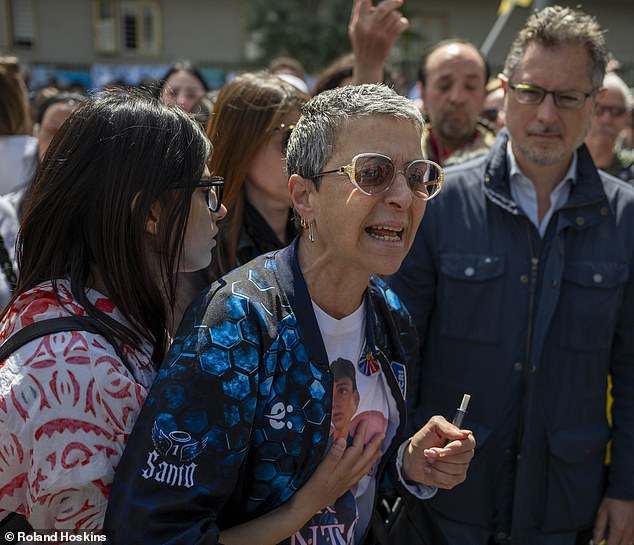 Santo's friends and family members, including his great-aunt, Arca Vaccaro, centre, protested outside the courthouse, wearing T-shirts displaying his handsome face