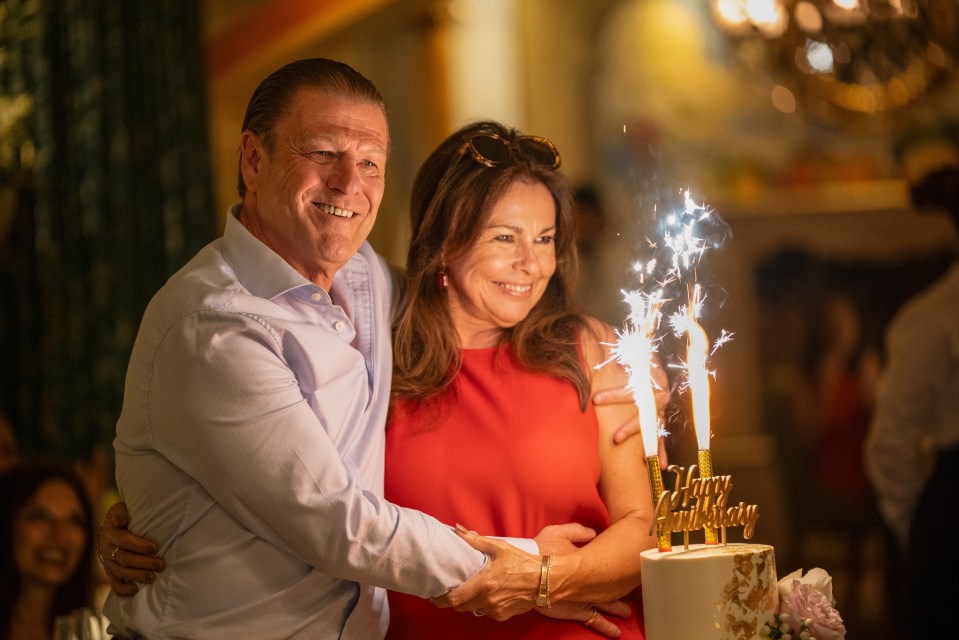 Ronnie Phelan and Elaine Phelan celebrating with an anniversary cake.