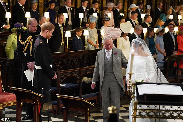 Charles walks Meghan down the aisle for her wedding to Harry at Windsor Castle in May 2018