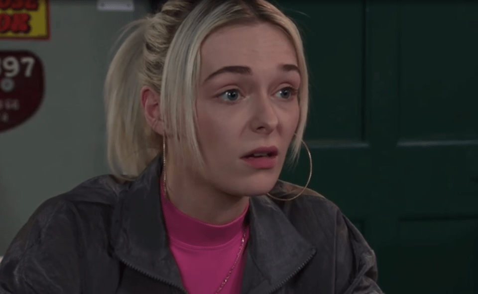 Woman with blonde hair looking concerned.