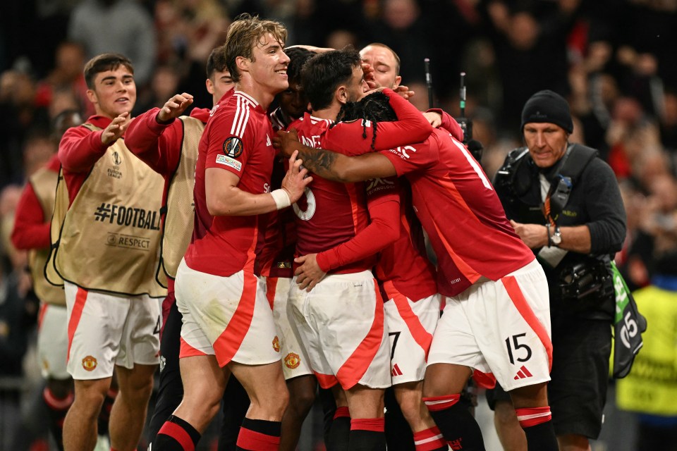 Manchester United players celebrating a goal.
