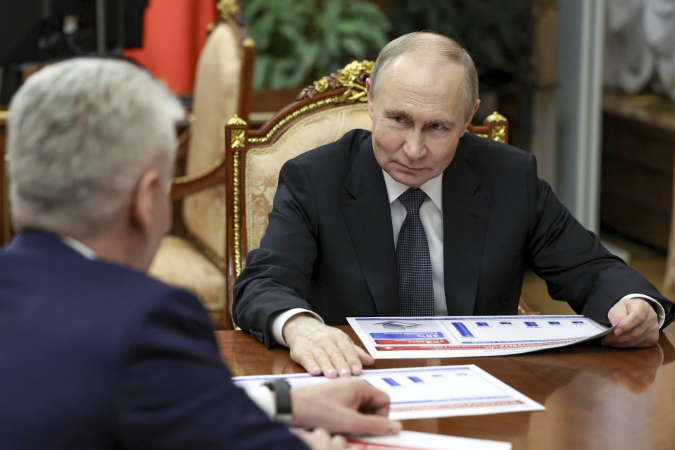 Vladimir Putin reviewing documents with Moscow Mayor Sergei Sobyanin.
