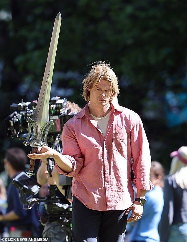 Meanwhile The Idea Of You favourite, 30, looked worlds away as he sported a long blonde wig and wore a pink shirt with dark denim while playing the iconic sword-wielding hero