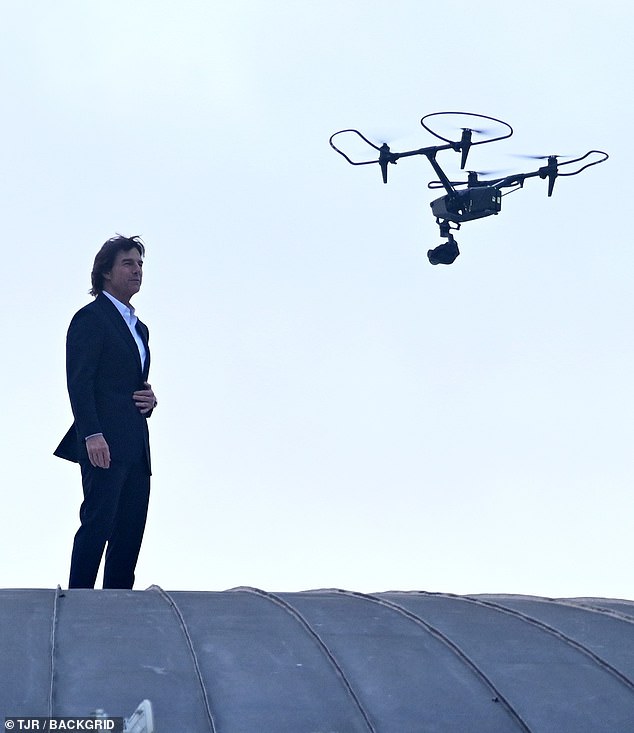 There weren't any camera operators visible on the roof, but a drone camera was spotted hovering just feet away from him