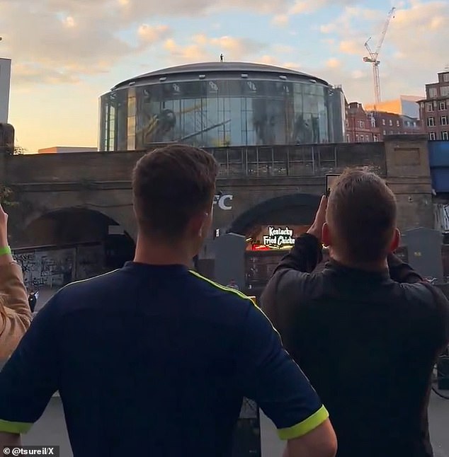 Fans in awe of the display snapped photos and shot video of the Minority Report star on top of the theater