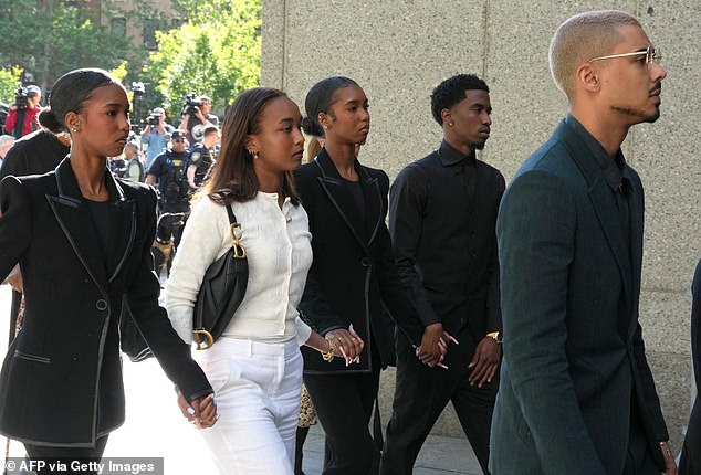 All of Diddy's kids, including his adopted son Quincy Brown (right) - the biological son of the rapper's late ex-girlfriend Kim Porter - showed up to support their father