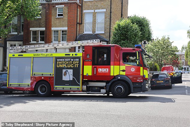 Firefighters are pictured at the scene of the blaze, with crews putting out the fire at about 1.33am