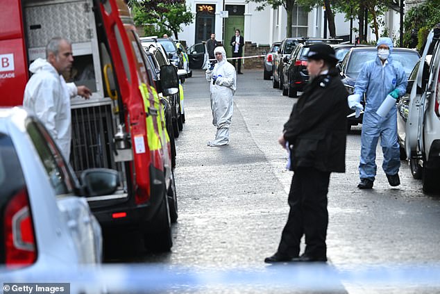 A forensics team is pictured working inside a police cordon as an officer looks on -- May 12, 2025