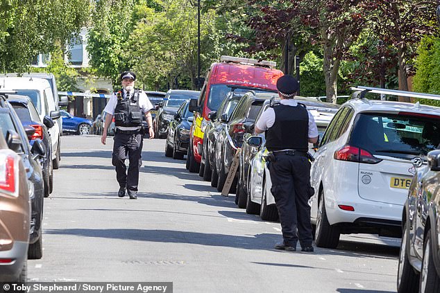 The home is owned by Sir Keir but he now rents it out while he lives in 10 Downing Street. Pictured are officers at the scene following the fire in London on Monday morning