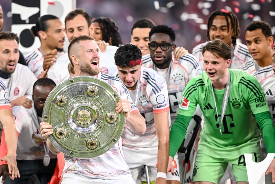 Eric Dier of Bayern Munich holding the Bundesliga championship trophy.