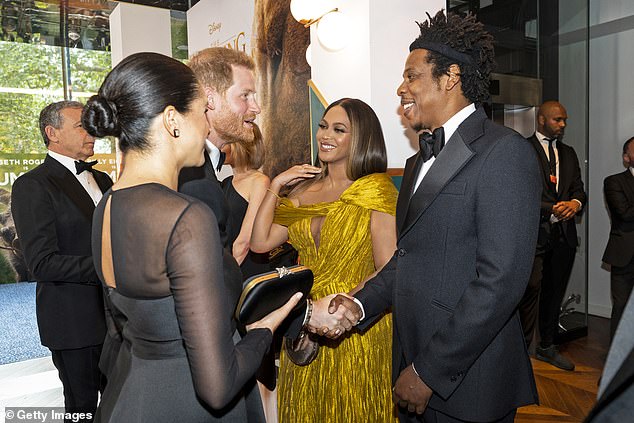 Harry shakes hands with Beyonce's husband Jay-Z during the Lion King premiere