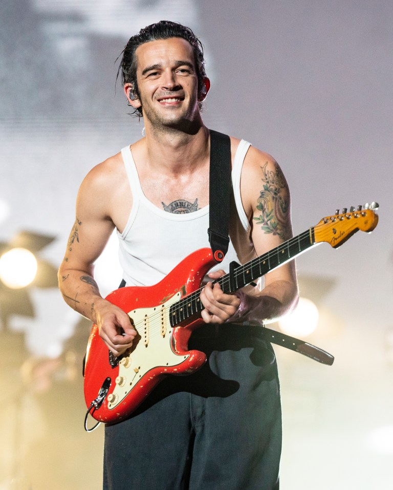 Matty Healy of The 1975 playing guitar at Lollapalooza.