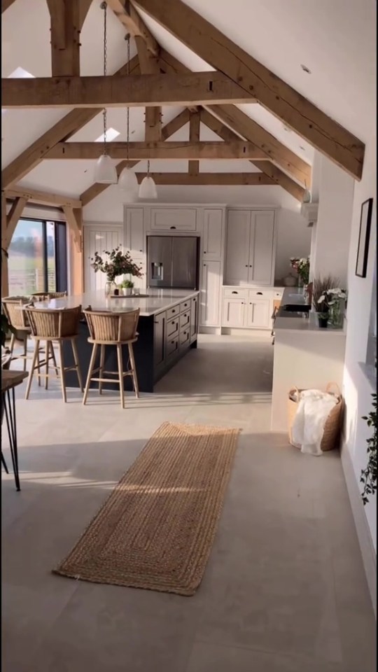 Modern kitchen with exposed wooden beams and a large island.