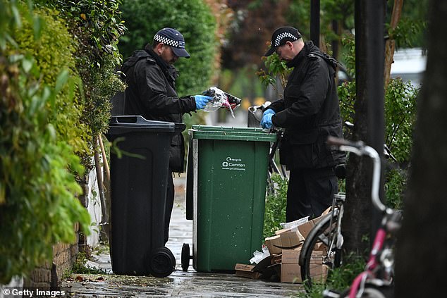 Police officers were pictured today looking through rubbish bins for any potential evidence -- May 12, 2025