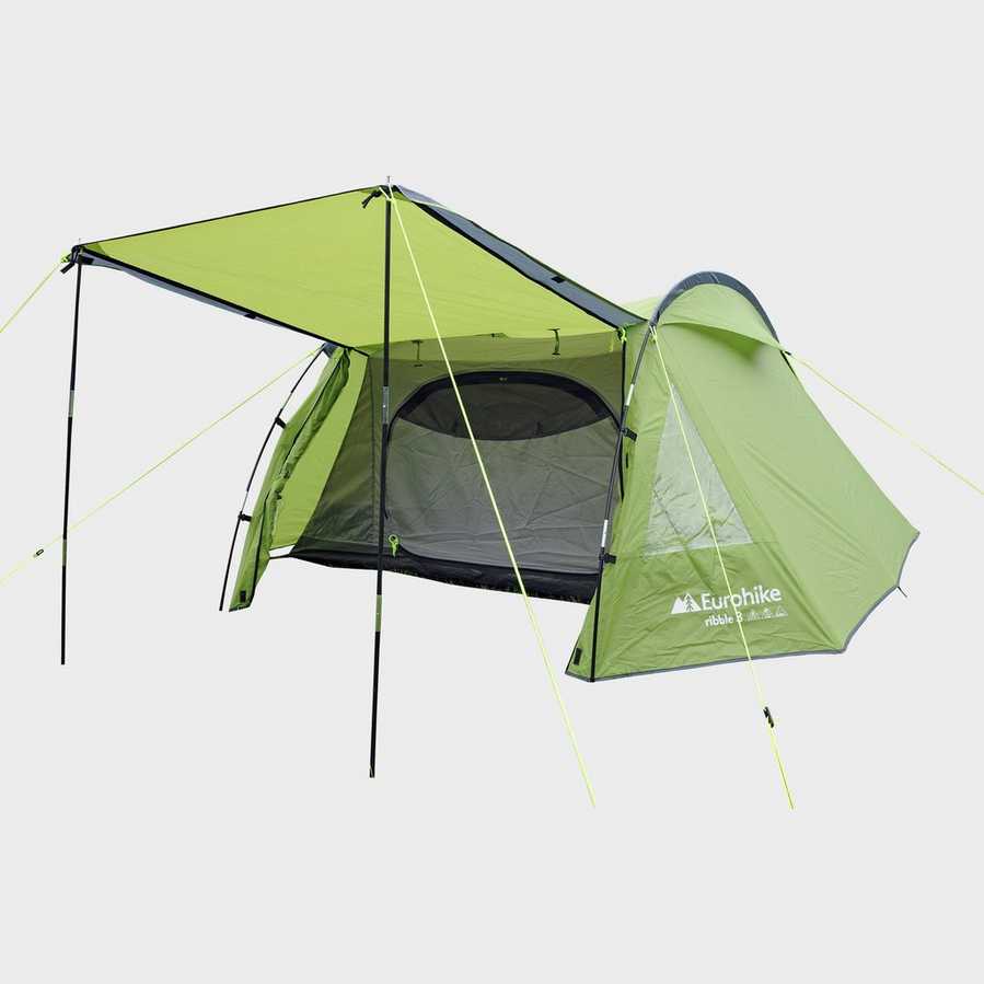 Green camping tent with attached awning.