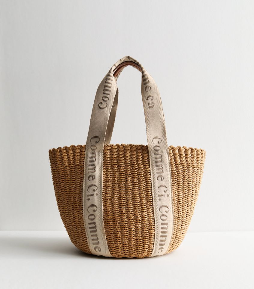 Brown straw tote bag with beige straps featuring logo.