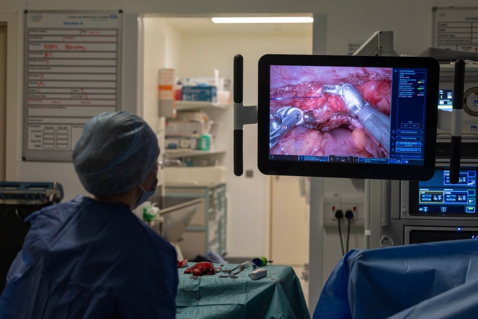 Robotic surgery in progress, viewed on a monitor in an operating theatre.