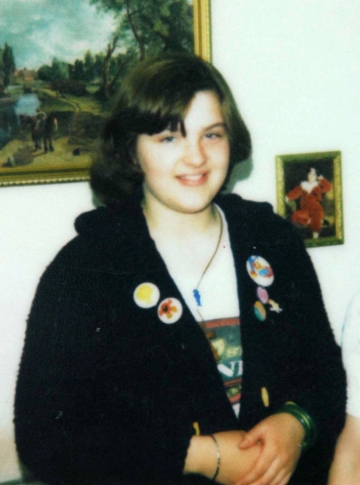 Photo of a young girl wearing a black cardigan with buttons.