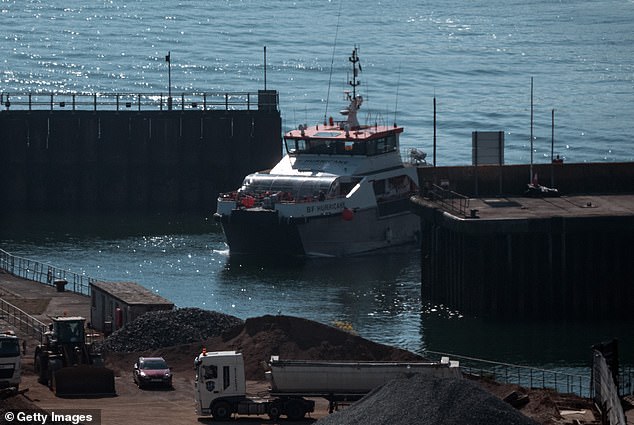 Migrants are seen being brought into port on board a Border Force vessel today in Dover, Kent