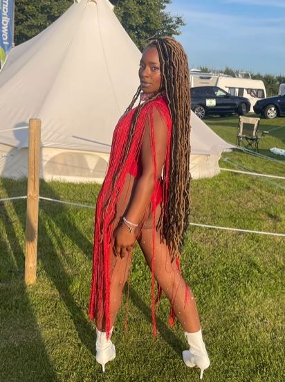 Woman in red fringed outfit and white boots.