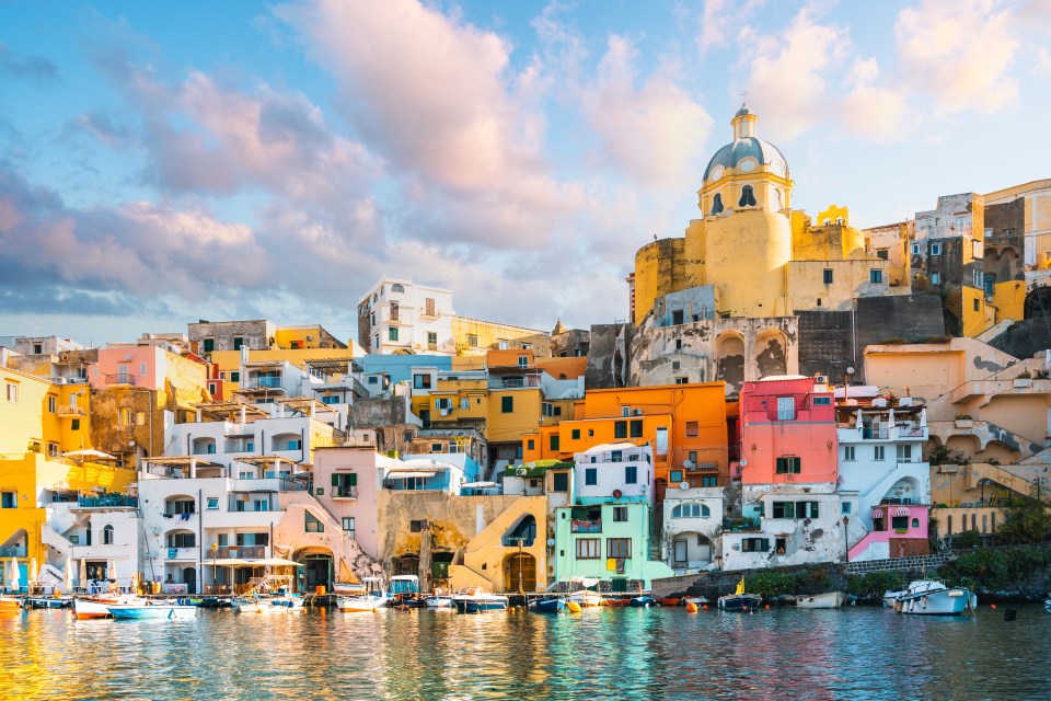 Colorful houses and boats in a Mediterranean town.