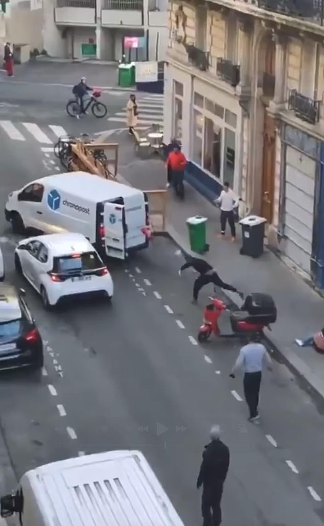 Passers-by can be seen arriving on the scene ready to assist as the assailants scrambled to freedom