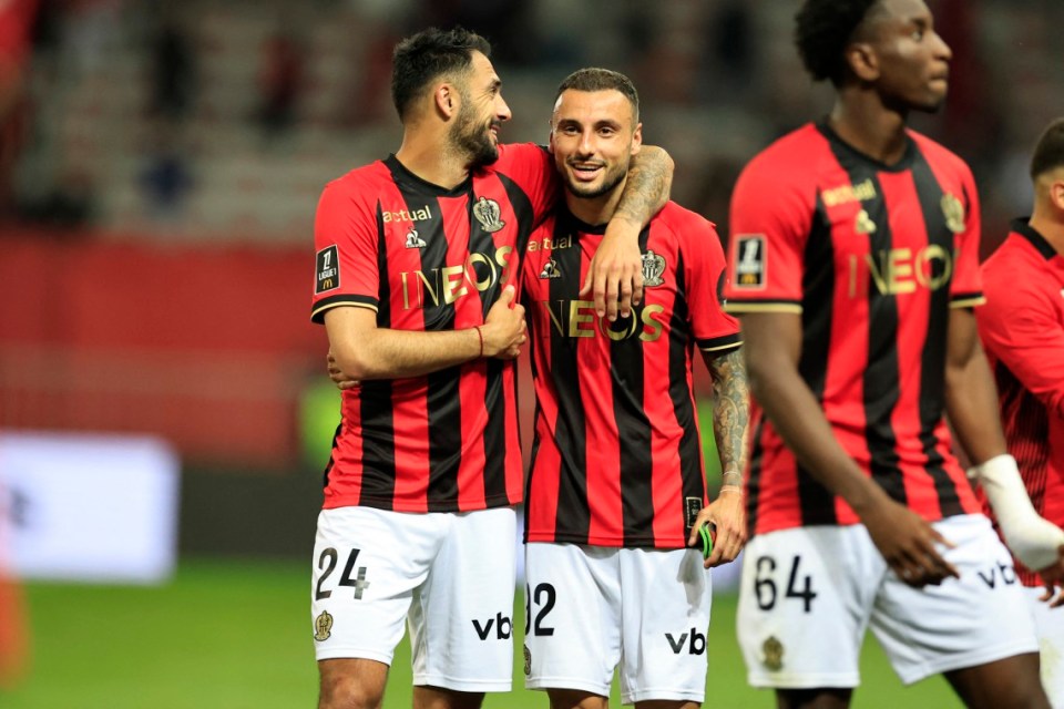 Nice's French forward #24 Gaetan Laborde (L) and Nice's French defender #92 Jonathan Clauss (C) celebrate their team's victory at the end of the French L1 football match between OGC Nice and Stade de Reims at the Allianz Riviera Stadium in Nice, south-eastern France, on May 2, 2025. (Photo by Valery HACHE / AFP) (Photo by VALERY HACHE/AFP via Getty Images)