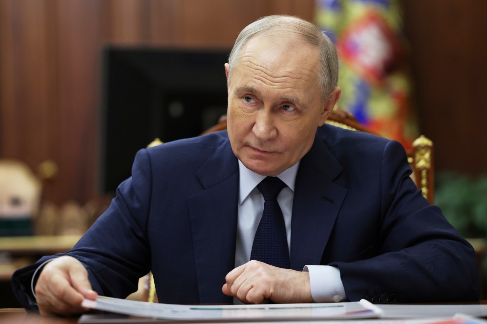Vladimir Putin listening attentively.