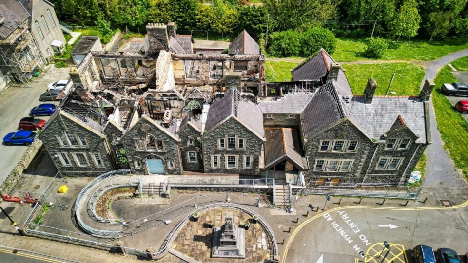 Aerial view of a fire-damaged Jacobean mansion.