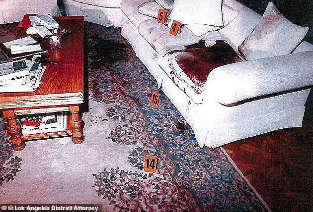 A chilling crime scene photo shows the blood-soaked couch where Jose Menendez was shot